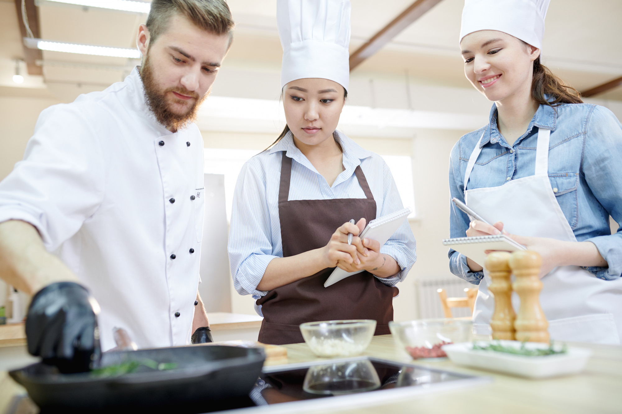 Workshop chef demonstrating technique to small group